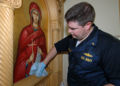 U.S. Navy Chaplain Lt. Michael Hendrickson helps clean up the Greek Orthodox Church of New Orleans after Hurricane Katrina.jpg
